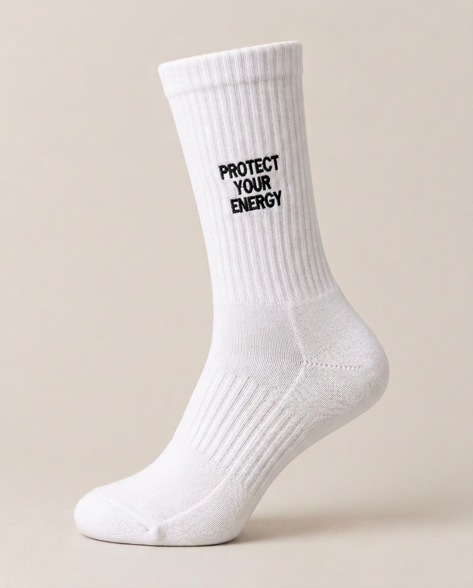 White ribbed crew sock with black PROTECT YOUR ENERGY embroidery.