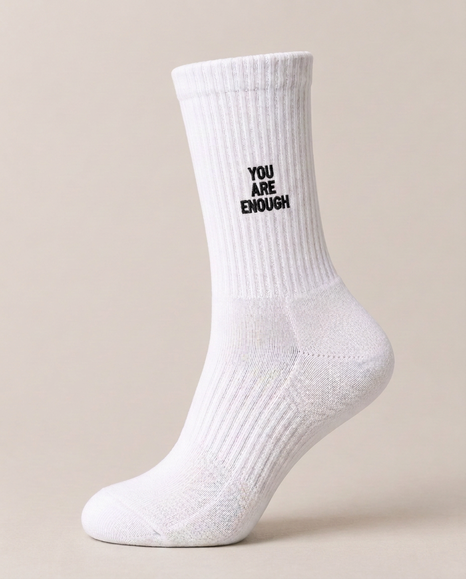 White ribbed crew sock with black YOU ARE ENOUGH embroidery.